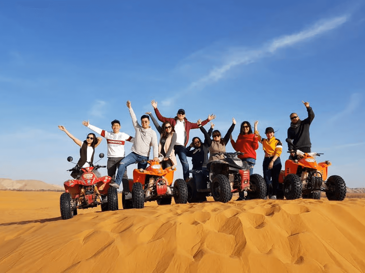 Riding an all-terrain vehicle (ATV) across the Red Sand Dunes Mui Ne